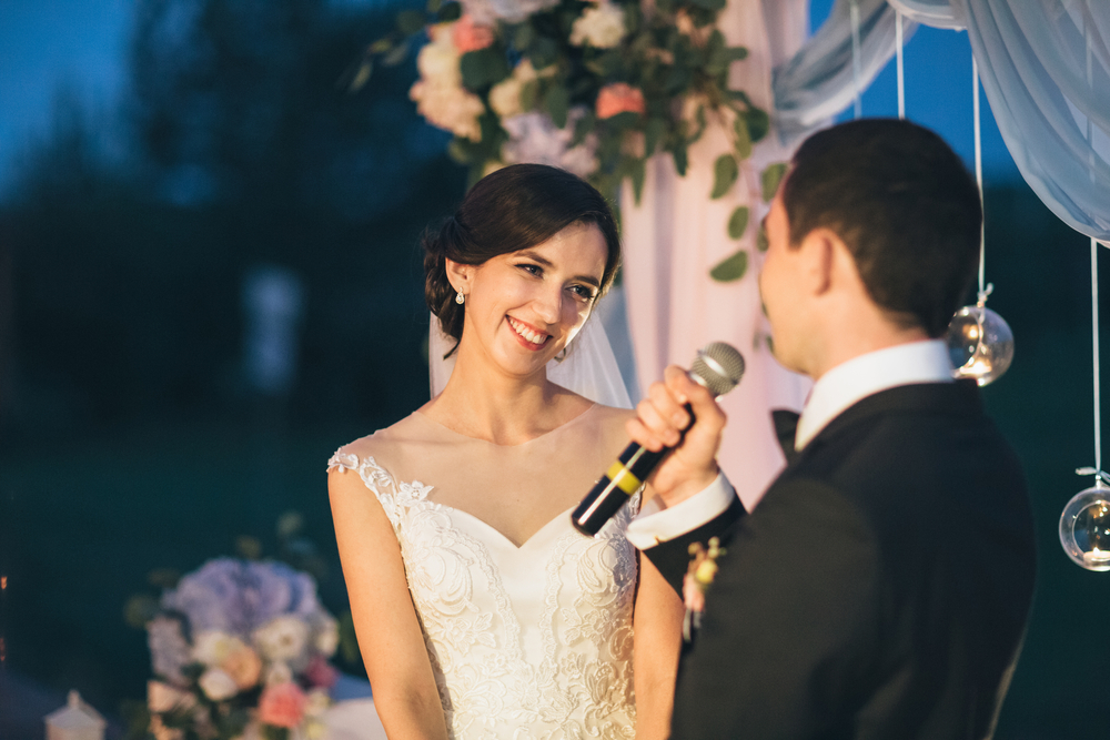 The groom keeps a microphone and speeking to his bride