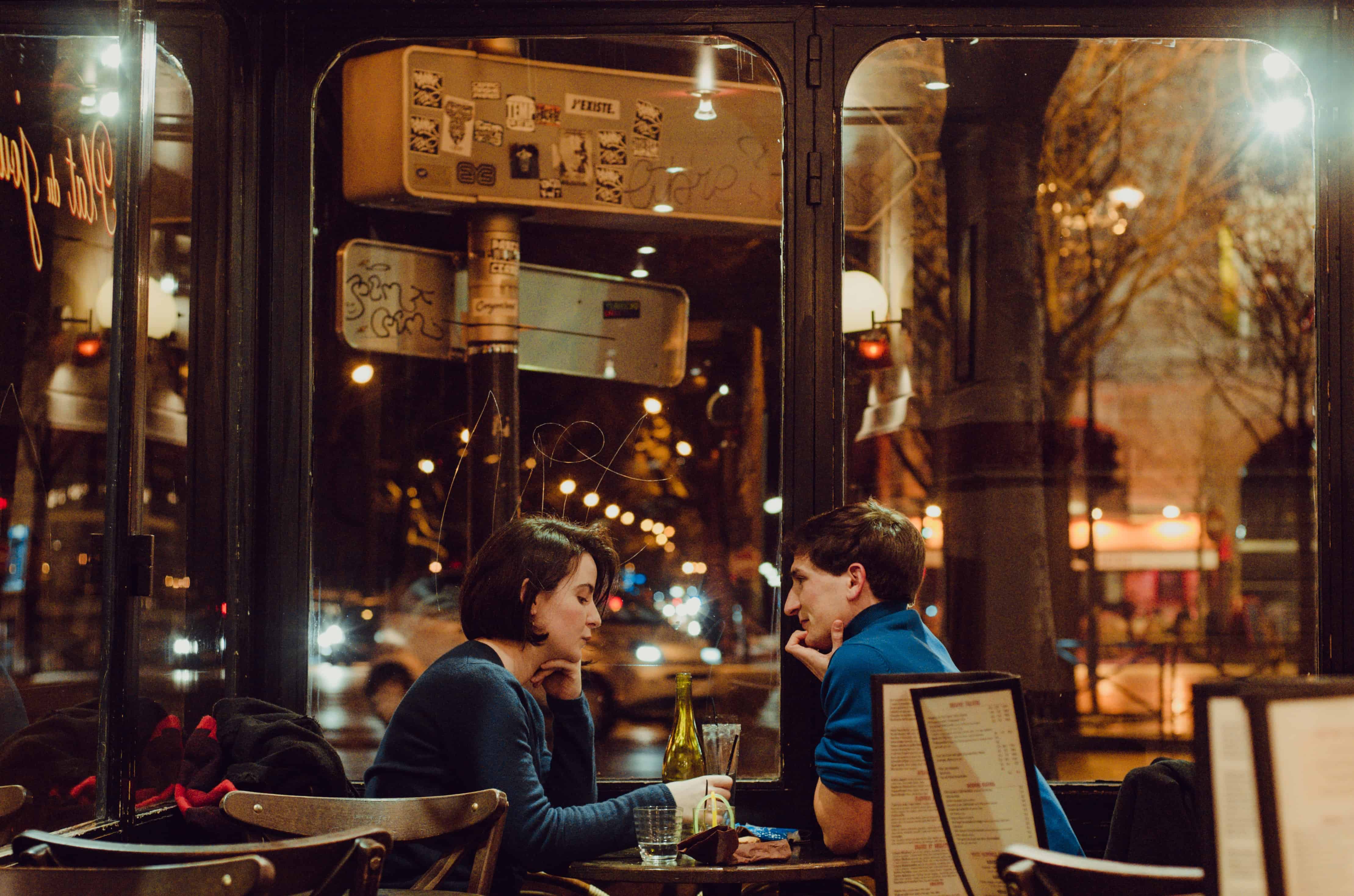 couple sitting near table inside cafe