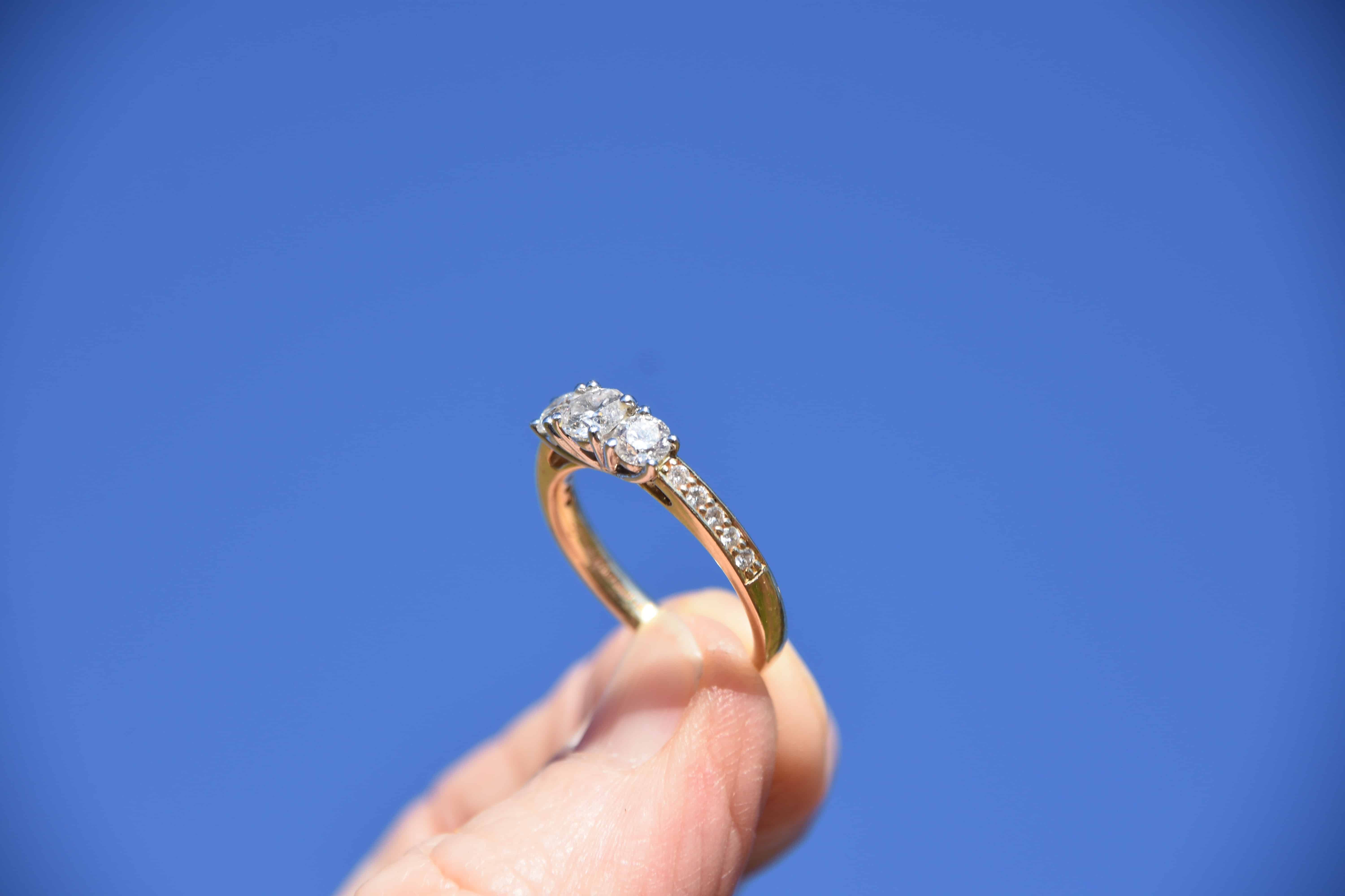 person holding gold-colored ring