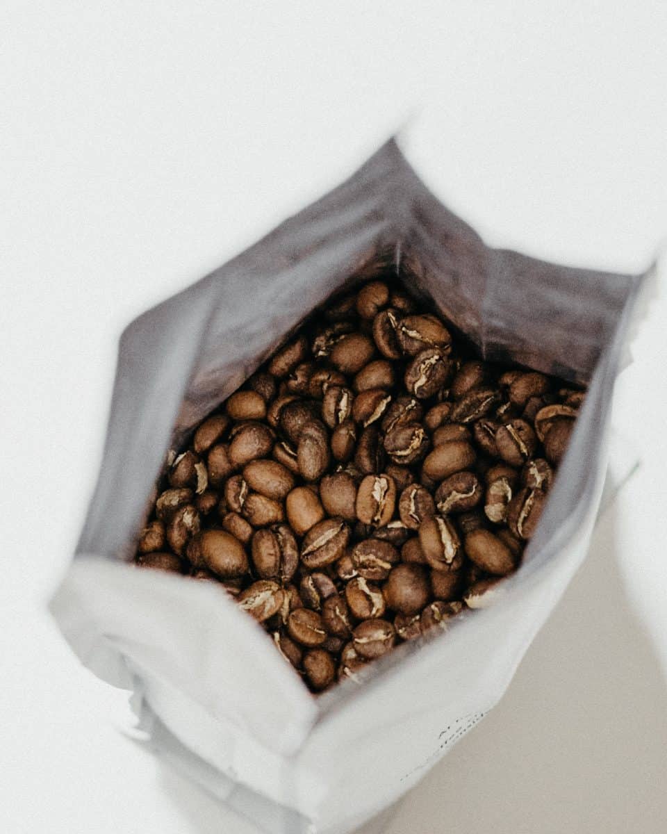 brown coffee beans inside white sack