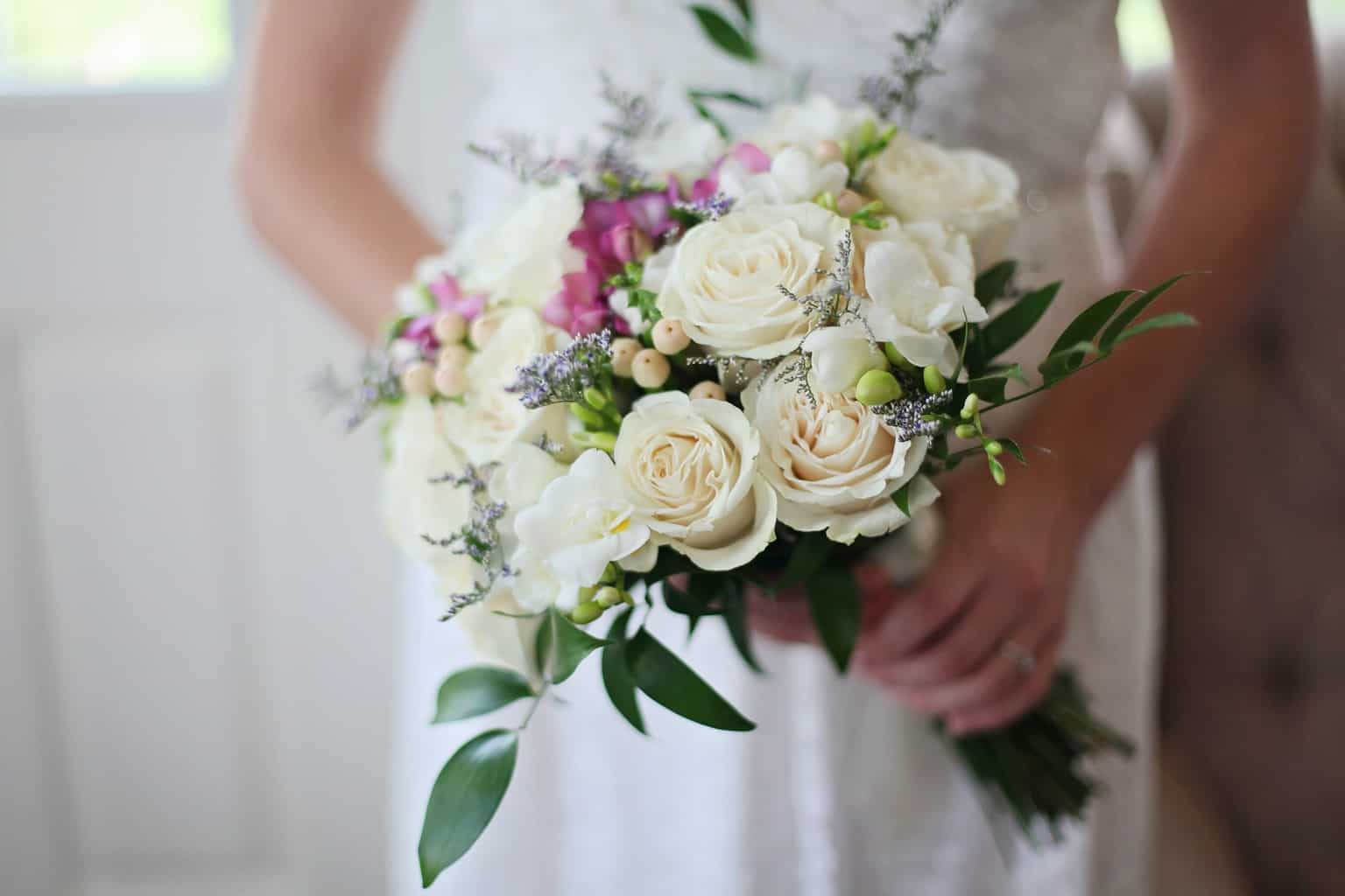 Brides Holding White Bouquet of Roses