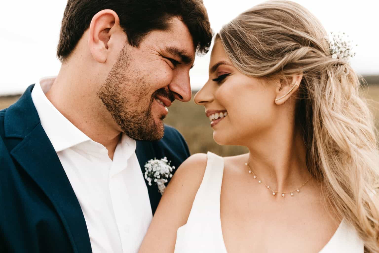 Man and Woman Facing Each Other While Smiling during Day