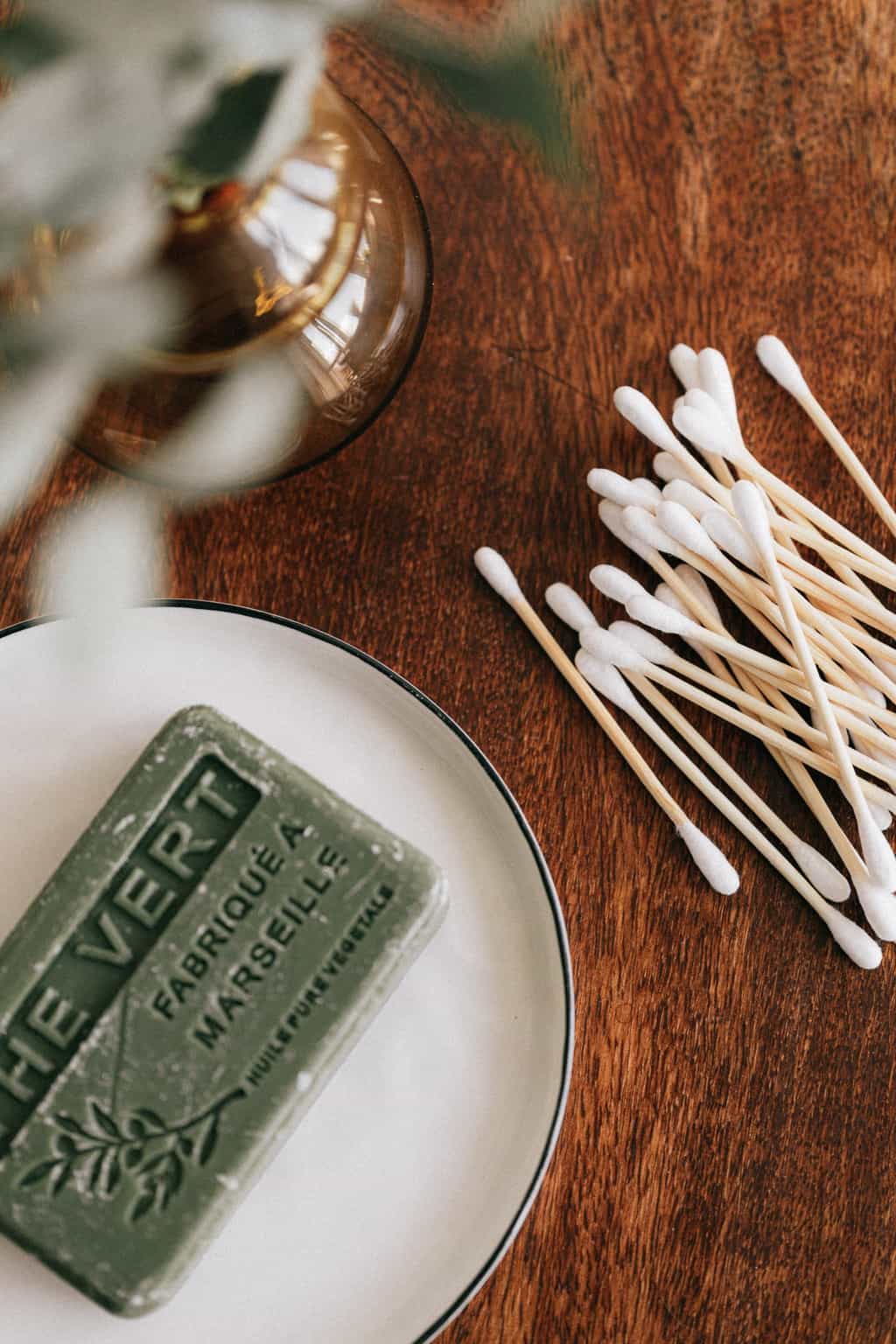 Wooden table with soap and ear sticks