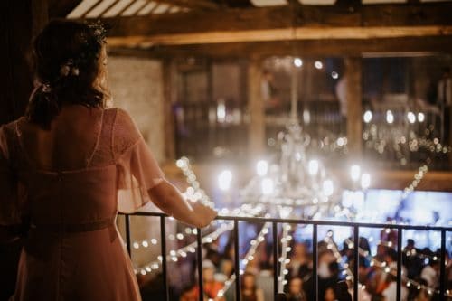 A person holding a microphone in front of a crowd of people Description automatically generated with low confidence