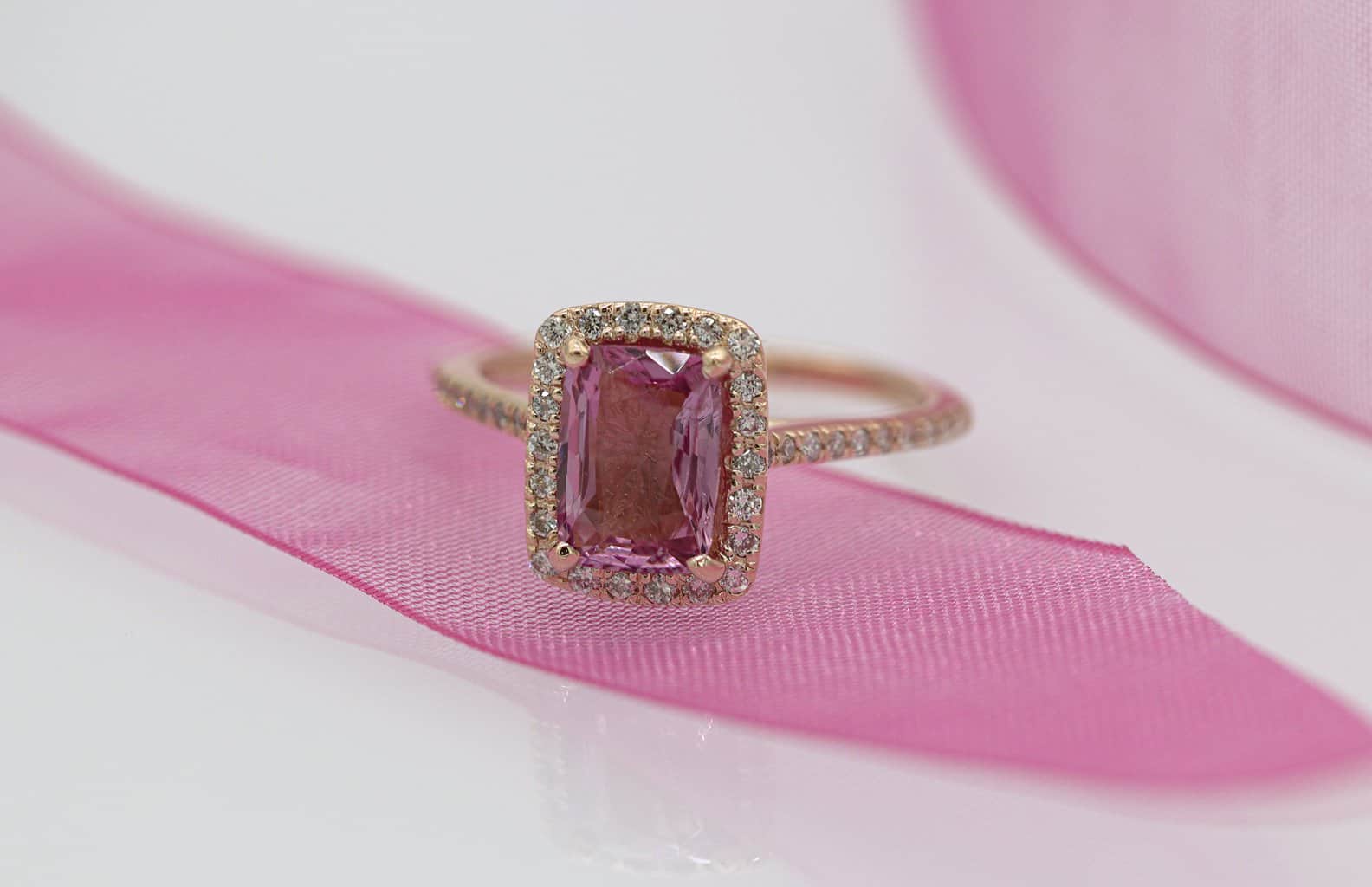 gold and silver ring on pink textile