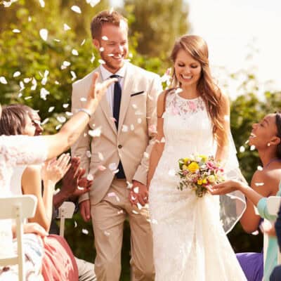 Guests Throwing Confetti Over Bride And Groom At Wedding